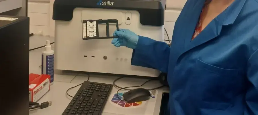 A picture of a technician standing by the Stilla Technologies Naica digital PCR platform